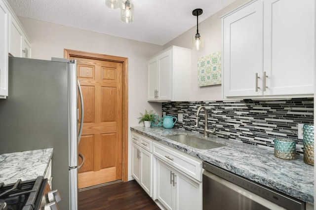 8824 134th St W, Apple Valley, MN 55124 - kitchen with stainless steel appliances, decorative backsplash, white cabinets, dark wood-type flooring, and light stone countertops
