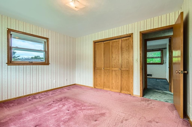 53 Morningside Dr, Saint Paul, MN 55119 - unfurnished bedroom with wallpapered walls, carpet, and a closet
