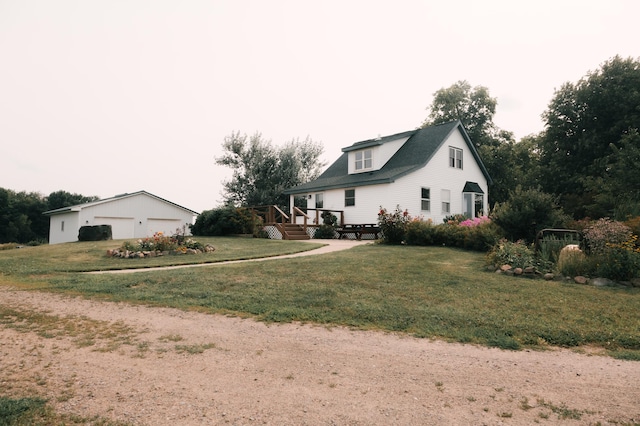 2834 150th St, Luck, WI 54837 - view of side of property featuring a garage, a lawn, and an outbuilding