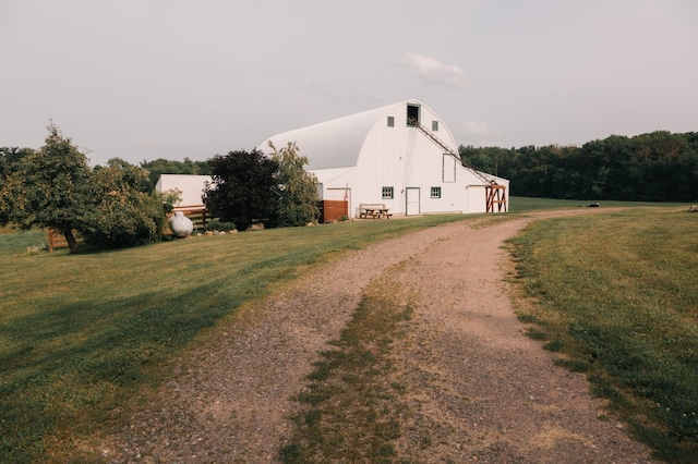 2834 150th St, Luck, WI 54837 - view of side of property with a barn, driveway, and a lawn