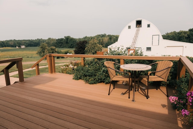 2834 150th St, Luck, WI 54837 - deck featuring a barn, a garage, and an outbuilding