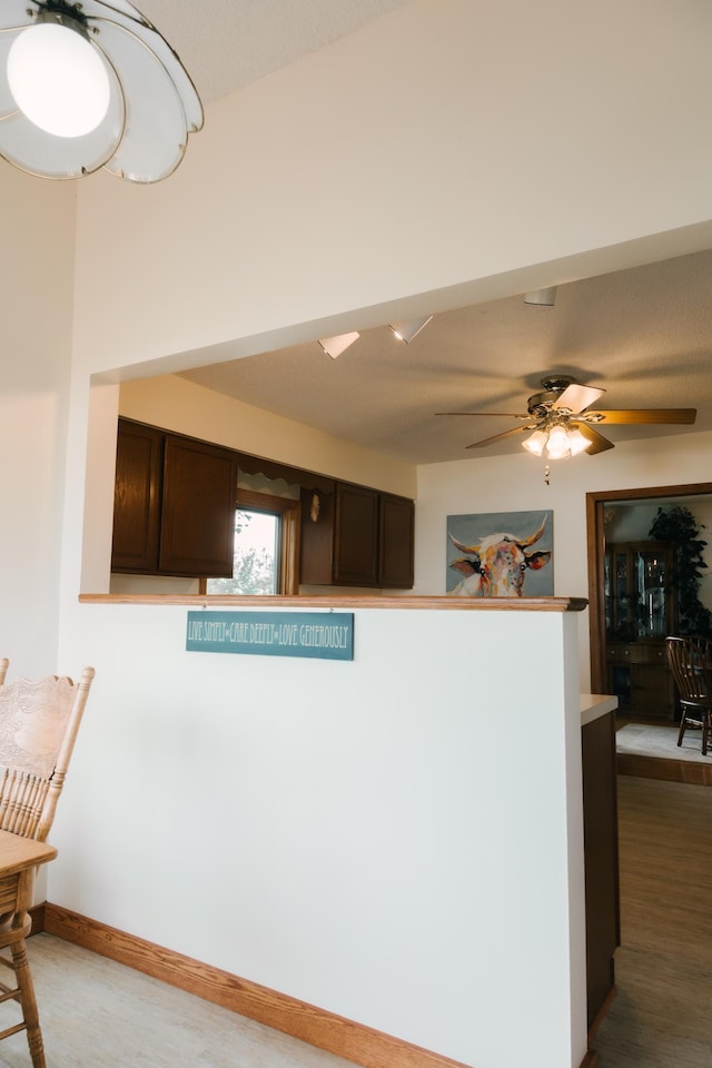 2834 150th St, Luck, WI 54837 - kitchen featuring dark brown cabinetry, a ceiling fan, and light countertops