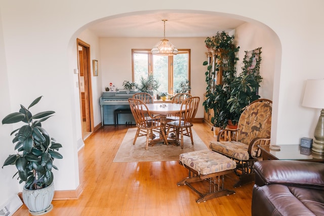 2834 150th St, Luck, WI 54837 - dining space featuring arched walkways and light wood-style floors
