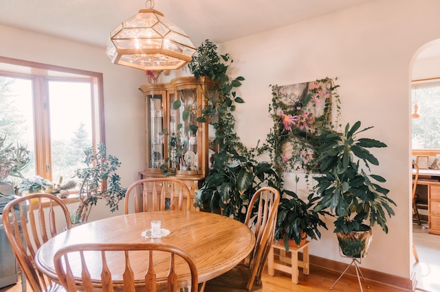 2834 150th St, Luck, WI 54837 - dining area featuring arched walkways and light wood finished floors