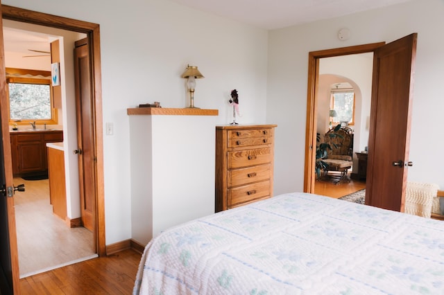 2834 150th St, Luck, WI 54837 - bedroom with wood finished floors, multiple windows, and arched walkways