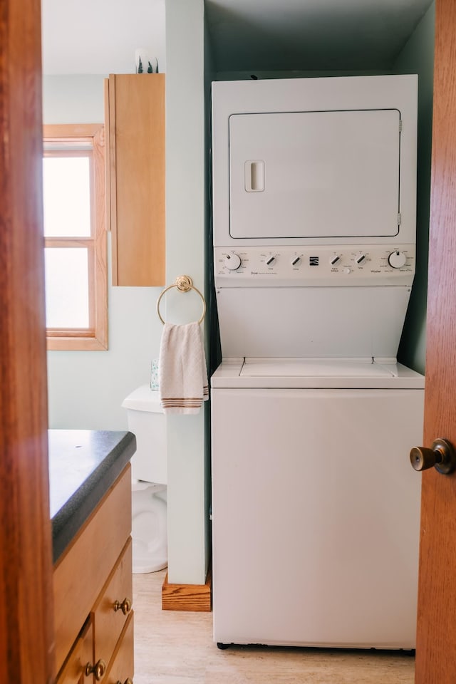 2834 150th St, Luck, WI 54837 - laundry room with stacked washer and clothes dryer and light wood-type flooring