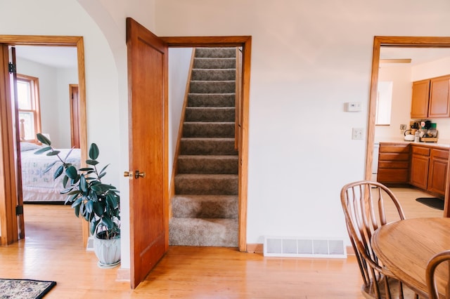 2834 150th St, Luck, WI 54837 - staircase featuring wood finished floors and arched walkways