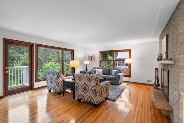 715 Forest Dale Rd, New Brighton, MN 55112 - living room featuring a fireplace and light wood-type flooring