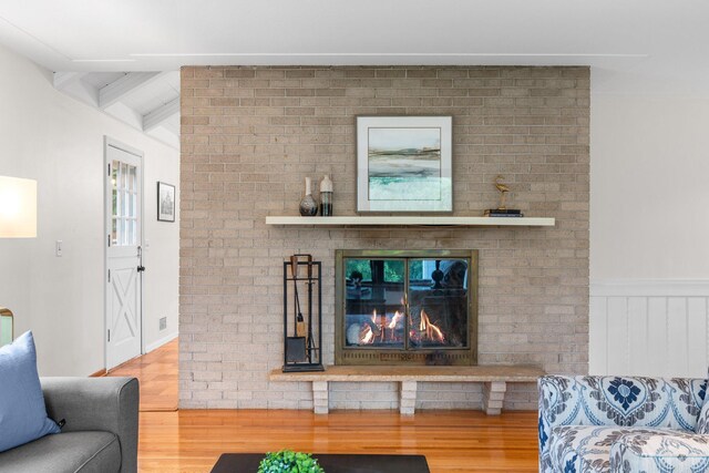 715 Forest Dale Rd, New Brighton, MN 55112 - living area with wood finished floors, beam ceiling, wainscoting, and a fireplace