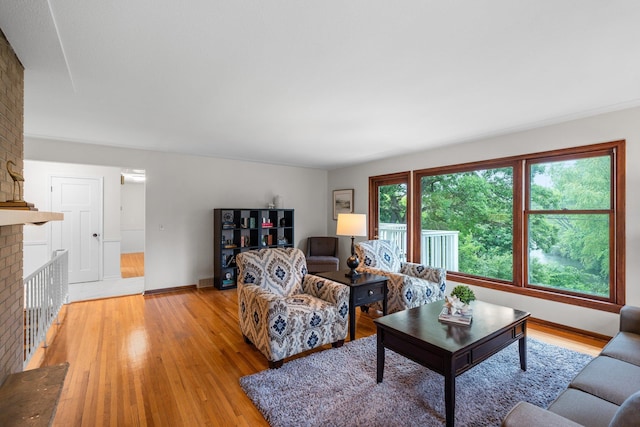 715 Forest Dale Rd, New Brighton, MN 55112 - living room featuring light wood-style flooring and a brick fireplace