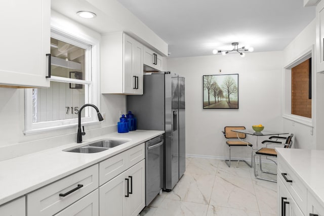 715 Forest Dale Rd, New Brighton, MN 55112 - kitchen with light marble finish flooring, light countertops, white cabinetry, and appliances with stainless steel finishes