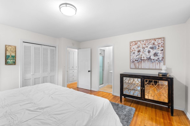 715 Forest Dale Rd, New Brighton, MN 55112 - bedroom featuring a closet, wood finished floors, and ensuite bathroom