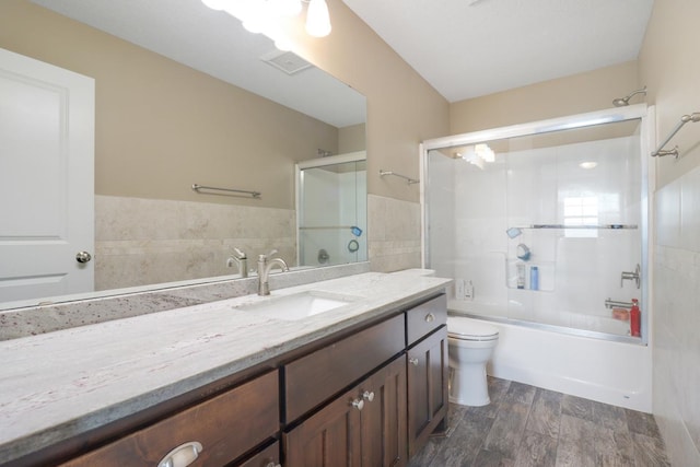 369 144th Ln NW, Andover, MN 55304 - bathroom featuring vanity, tile walls, bathing tub / shower combination, and wood finished floors