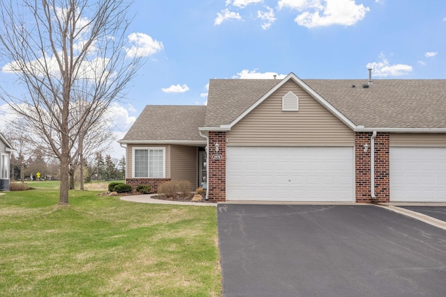 1978 110th Ct NE Unit 1103, Blaine, MN 55449 - view of front facade featuring brick siding, driveway, an attached garage, and roof with shingles