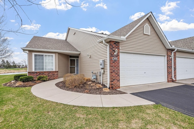 1978 110th Ct NE Unit 1103, Blaine, MN 55449 - view of front of house with brick siding, a garage, roof with shingles, asphalt driveway, and a front lawn