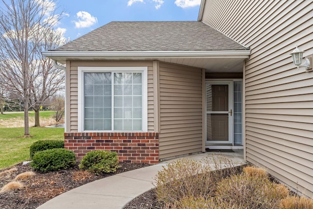 1978 110th Ct NE Unit 1103, Blaine, MN 55449 - doorway to property with a shingled roof and brick siding