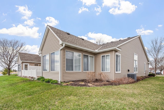 1978 110th Ct NE Unit 1103, Blaine, MN 55449 - view of side of property with a yard and a shingled roof