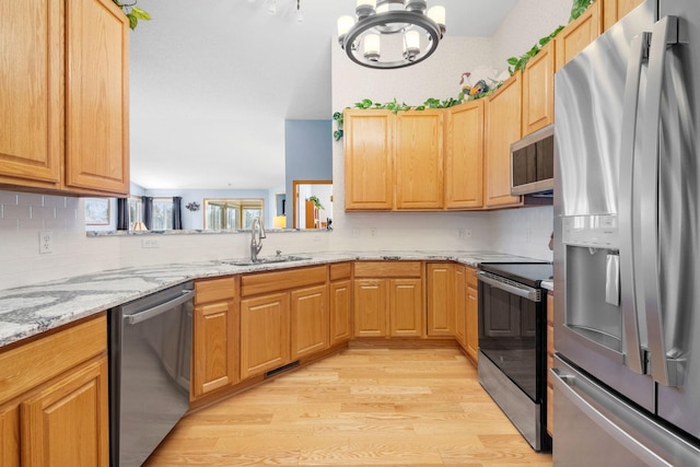 1978 110th Ct NE Unit 1103, Blaine, MN 55449 - kitchen with appliances with stainless steel finishes, light wood-style floors, and tasteful backsplash