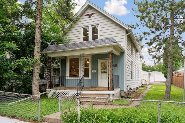 59 Winnipeg Ave, Saint Paul, MN 55117 - view of front of home with covered porch, a garage, board and batten siding, and an outdoor structure