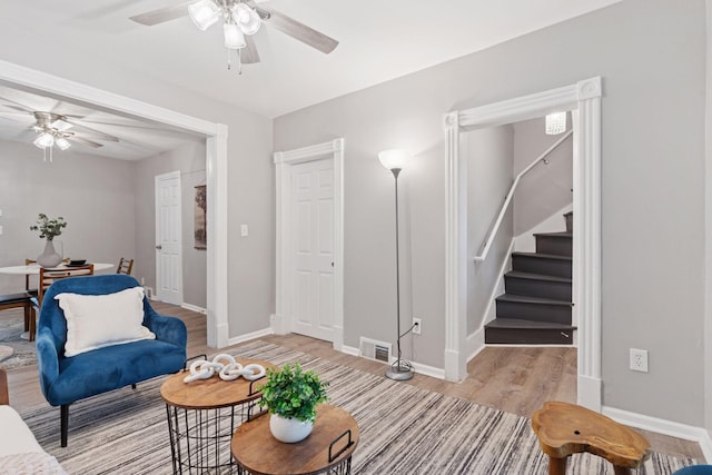 59 Winnipeg Ave, Saint Paul, MN 55117 - living area with ceiling fan, stairway, and light wood-style floors