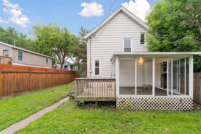 59 Winnipeg Ave, Saint Paul, MN 55117 - rear view of house featuring a fenced backyard, a sunroom, and a wooden deck