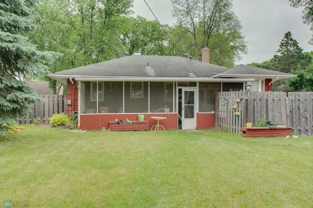1021 1st St S, Moorhead, MN 56560 - rear view of property featuring a sunroom, a chimney, and roof with shingles