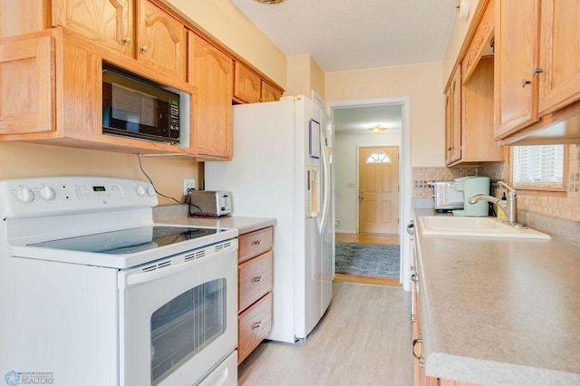 1021 1st St S, Moorhead, MN 56560 - kitchen with white appliances, light countertops, and light wood-style floors