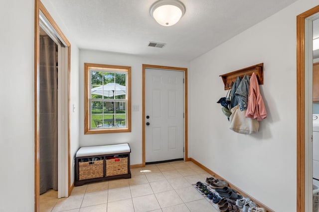 500 Cartway Rd, Champlin, MN 55316 - foyer with light tile patterned flooring and washer / dryer