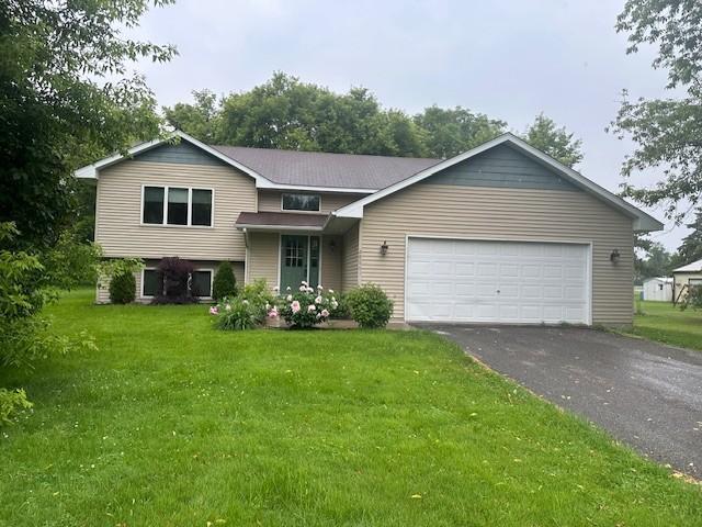 28065 Old Towne Rd, Chisago City, MN 55013 - tri-level home featuring driveway, an attached garage, and a front yard