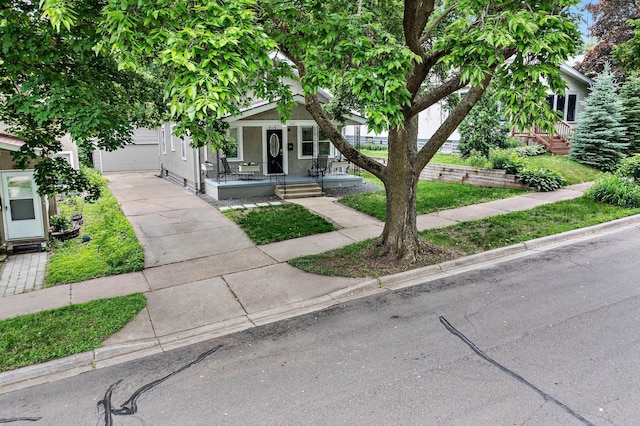 242 Winona St W, West Saint Paul, MN 55118 - view of front of home with a porch, concrete driveway, and an attached garage