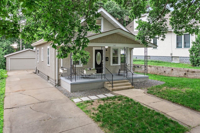 242 Winona St W, West Saint Paul, MN 55118 - view of front of house featuring a porch, a garage, an outdoor structure, a front yard, and stucco siding