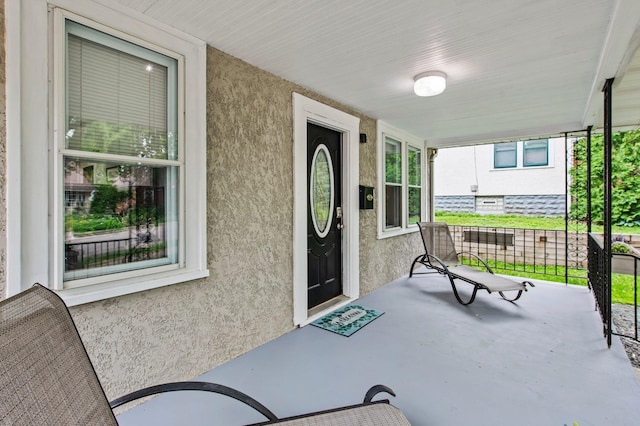 242 Winona St W, West Saint Paul, MN 55118 - property entrance featuring covered porch and stucco siding