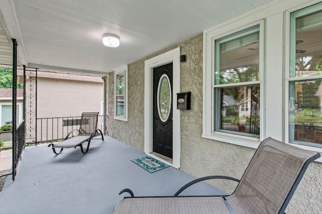 242 Winona St W, West Saint Paul, MN 55118 - view of exterior entry featuring covered porch and stucco siding