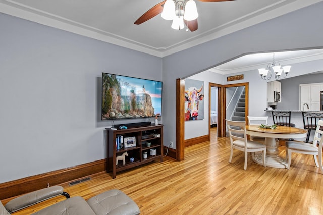 242 Winona St W, West Saint Paul, MN 55118 - dining room with stairs, ceiling fan, a chandelier, light wood-style flooring, and ornamental molding