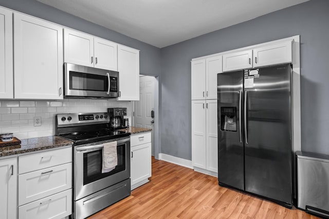 242 Winona St W, West Saint Paul, MN 55118 - kitchen with stainless steel appliances, light wood-style flooring, dark stone counters, and white cabinets