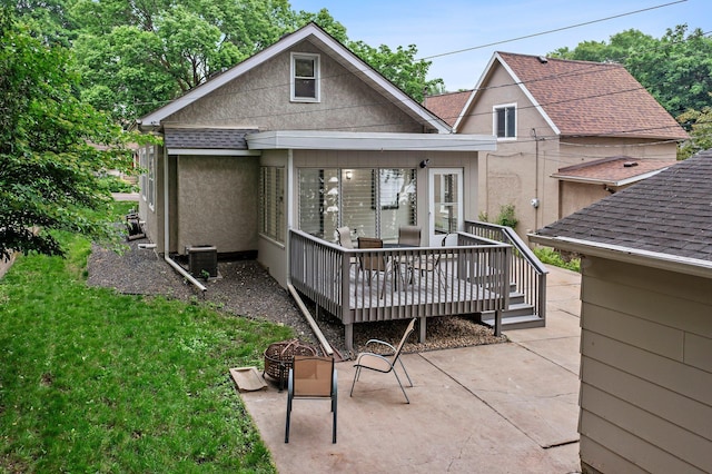 242 Winona St W, West Saint Paul, MN 55118 - back of property with a patio, stucco siding, a deck, a lawn, and a shingled roof