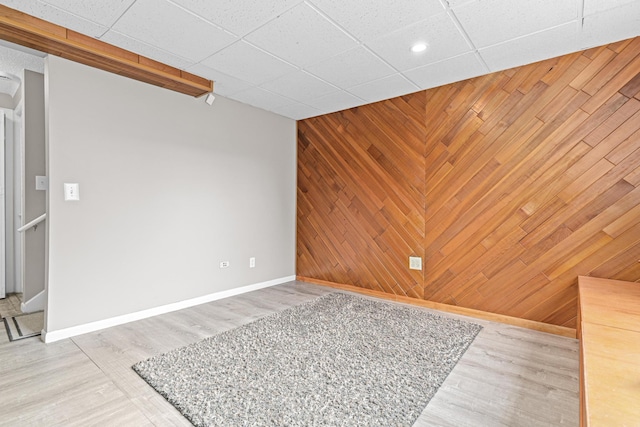 1824 4th Ave S, Minneapolis, MN 55404 - spare room featuring an accent wall, wooden walls, light wood-type flooring, and recessed lighting