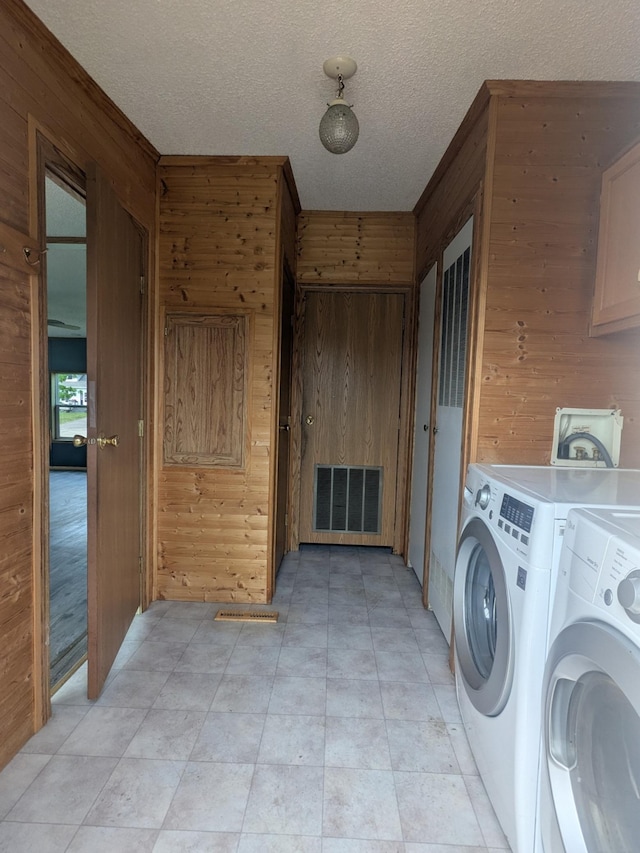 204 6th St W, Carlos, MN 56319 - laundry area with wooden walls, washing machine and clothes dryer, and a textured ceiling