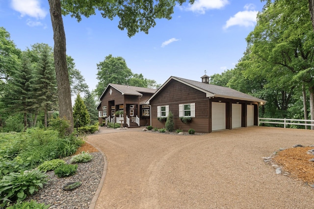 6300 78th Ln, Greenfield, MN 55357 - view of front of home featuring covered porch, dirt driveway, and roof with shingles