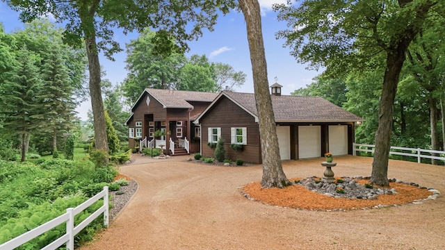 6300 78th Ln, Greenfield, MN 55357 - rustic home with concrete driveway, a garage, a porch, and a shingled roof