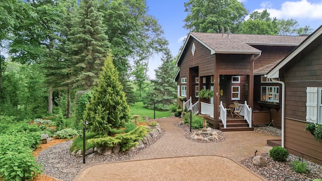 6300 78th Ln, Greenfield, MN 55357 - view of front of house featuring a shingled roof and a patio area