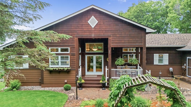 6300 78th Ln, Greenfield, MN 55357 - chalet / cabin featuring a shingled roof and a porch