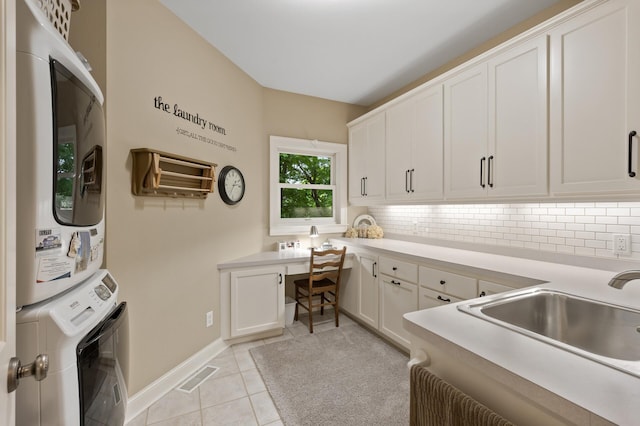 6300 78th Ln, Greenfield, MN 55357 - kitchen with stacked washer / drying machine, built in study area, tasteful backsplash, and light tile patterned floors