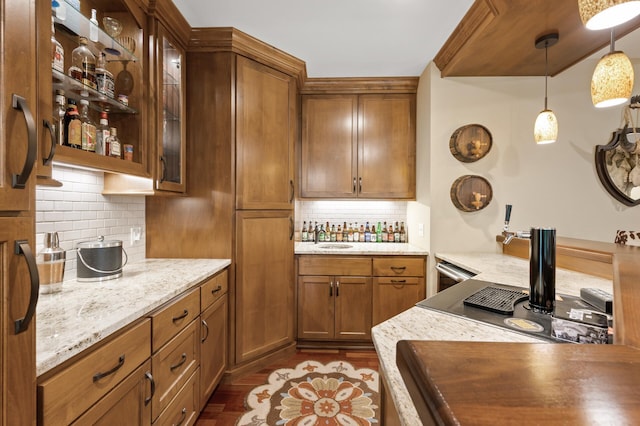 6300 78th Ln, Greenfield, MN 55357 - kitchen with brown cabinets, backsplash, dark wood-type flooring, hanging light fixtures, and glass insert cabinets