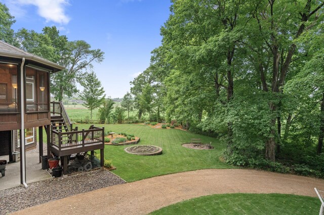 6300 78th Ln, Greenfield, MN 55357 - view of green lawn featuring a sunroom, stairway, a fire pit, and a patio