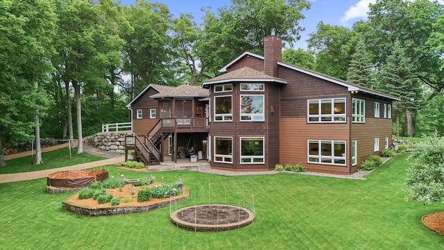 6300 78th Ln, Greenfield, MN 55357 - back of house with a chimney, a fire pit, a sunroom, stairway, and a lawn