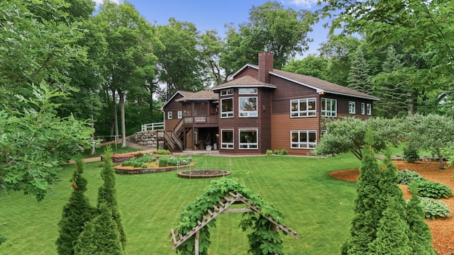 6300 78th Ln, Greenfield, MN 55357 - rear view of house with stairway, a chimney, a lawn, a sunroom, and a wooden deck