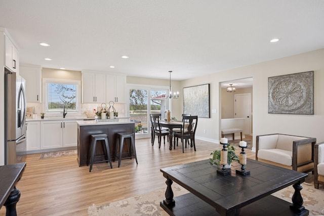 6676 Jason Ave NE, Monticello, MN 55362 - living area with light wood-type flooring, a chandelier, and recessed lighting