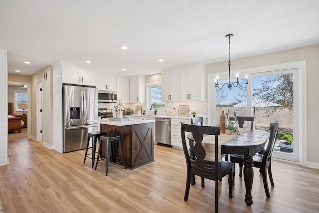 6676 Jason Ave NE, Monticello, MN 55362 - kitchen featuring appliances with stainless steel finishes, a kitchen island, white cabinetry, a chandelier, and recessed lighting