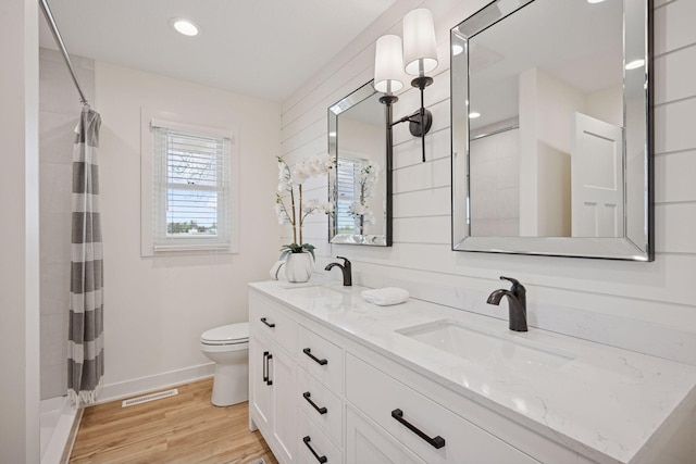 6676 Jason Ave NE, Monticello, MN 55362 - full bath with double vanity, wood finished floors, curtained shower, and recessed lighting